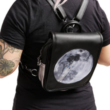 Load image into Gallery viewer, Model wearing Moon Ita Bag as a backpack on white background.