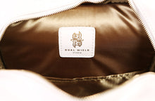 Load image into Gallery viewer, Detail of inner lining when bag is unzipped, showing the gold on white Dual Wield Studio logo.