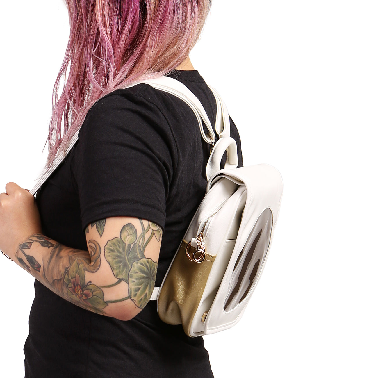 Side view of Sun Ita Bag worn as a backpack on model with black shirt.