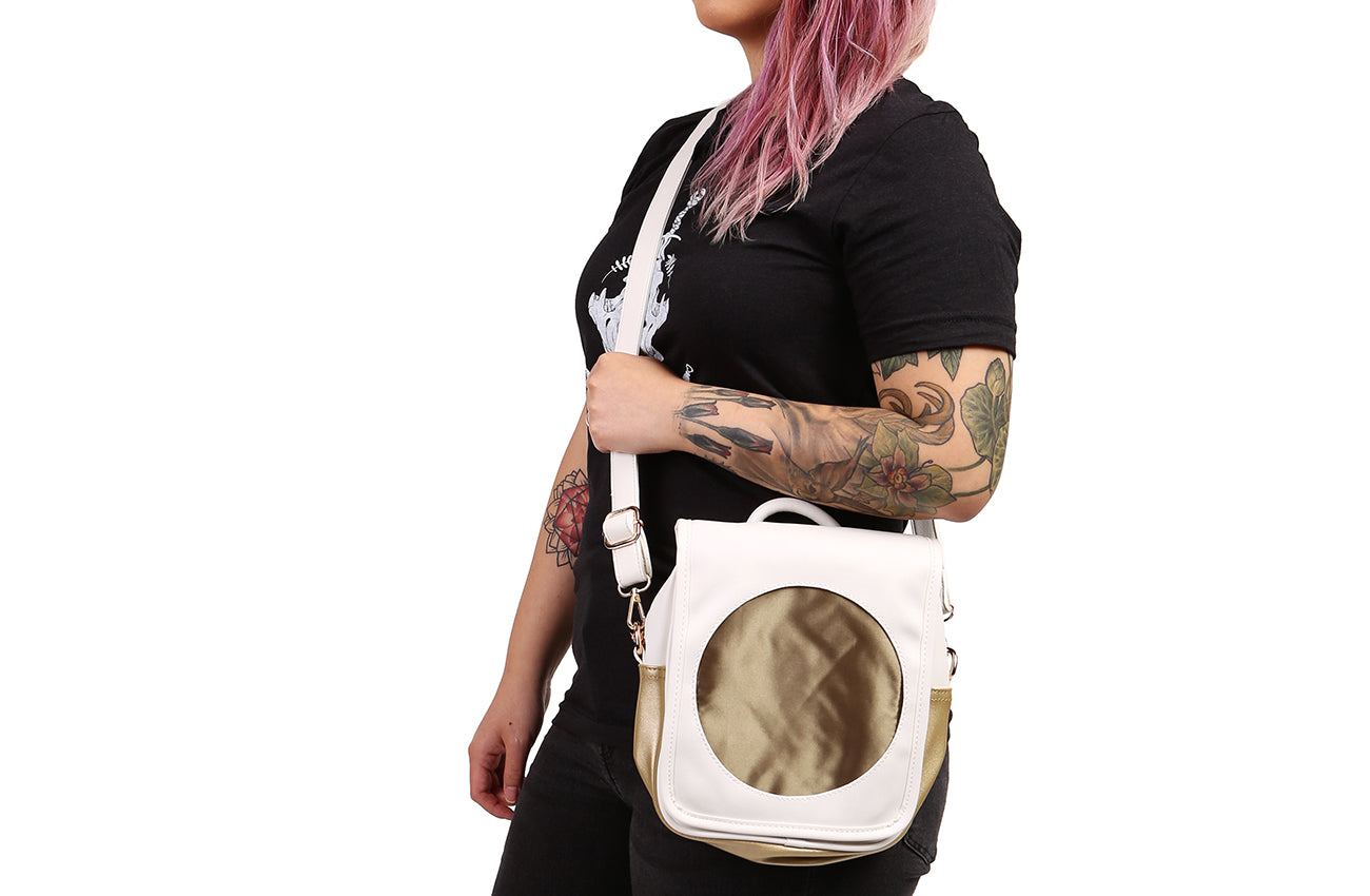 Sun Ita Bag worn as a crossbody bag by model with black shirt.