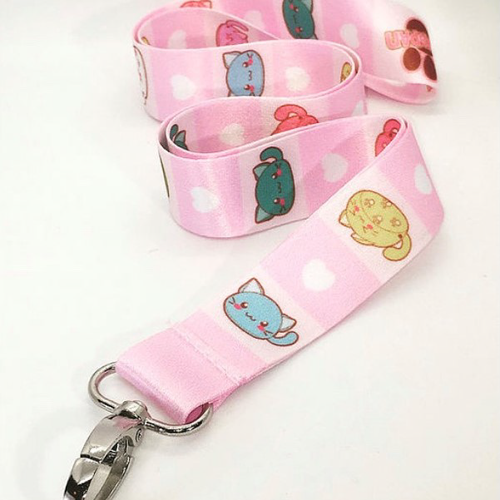 Closeup of pink striped Nekopan lanyard that depicts different cute cats of various colors. White background.