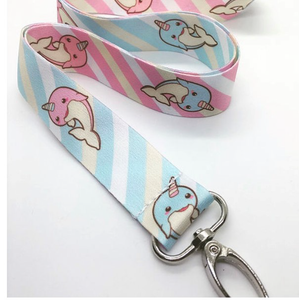 Closeup of pink and blue narwhal lanyard with silver clasp on white background.