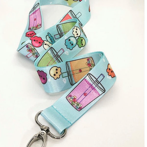 Light blue Boba lanyard with cute, smiling, multicolored octopus creatures. White background.