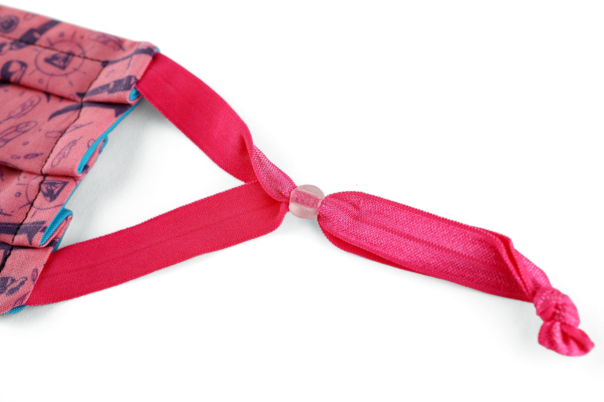 Detail of hot pink adjustable ear loops on Weapons & Spells mask.