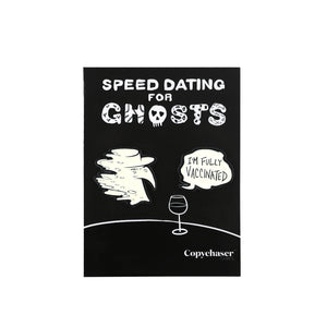 Black and white glow in the dark Spooky Peter Pin Set on their backing card, which depicts a simplified black and white table and wine glass with Speed Dating for Ghosts logo.