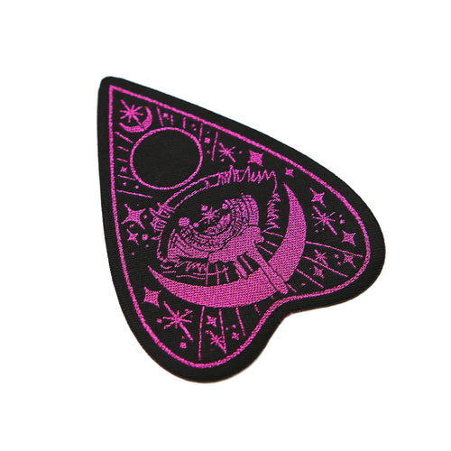 Black planchette patch with magenta detailing on white background.