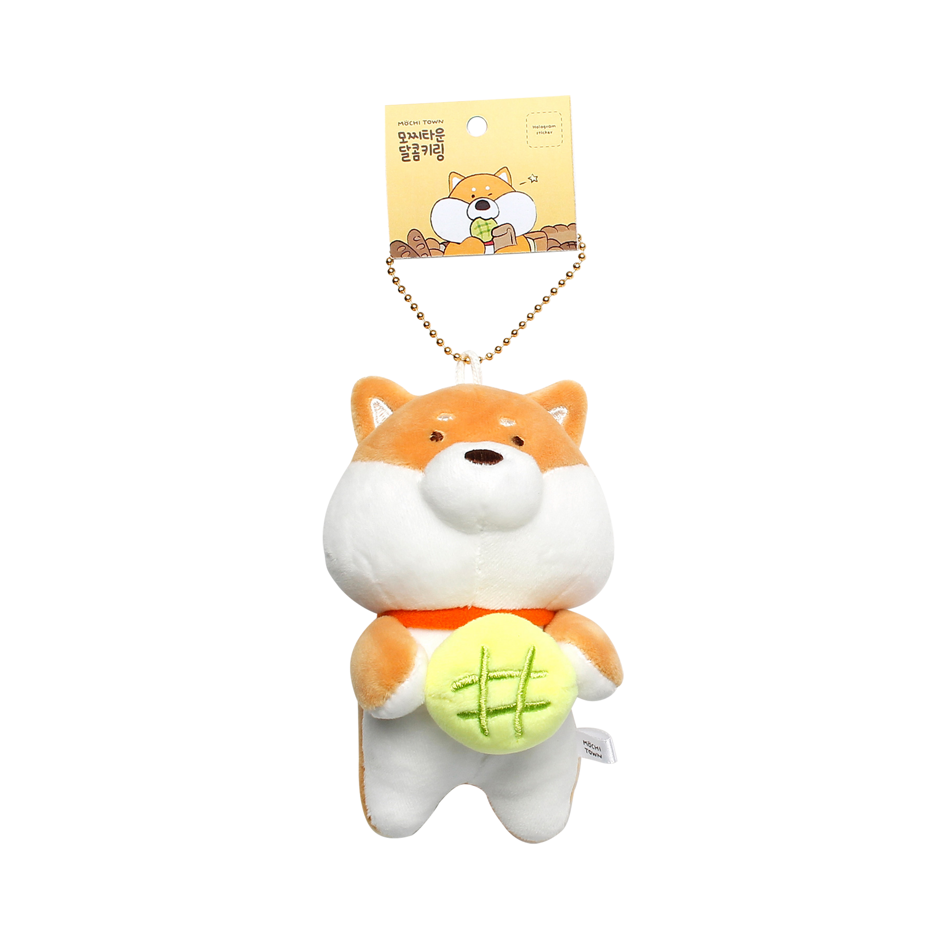 Tan and white shiba with green roll keyring hanging from tag on white background.