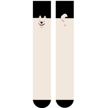 Load image into Gallery viewer, Shin length pair of cream and black socks with dog face and tail/butt details on either side. White background.