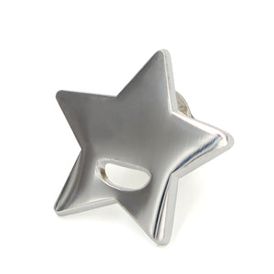 Silver star charm pin on white background.