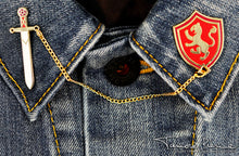 Load image into Gallery viewer, Alanna Sword and Shield pins on each lapel across a denim shirt.