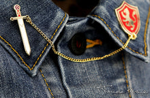 Load image into Gallery viewer, Angled view of Sword and Shield pins worn on denim lapels.