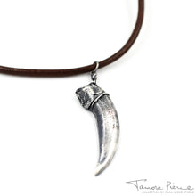 Load image into Gallery viewer, Silver badger claw pendant on brown necklace cord on white background.