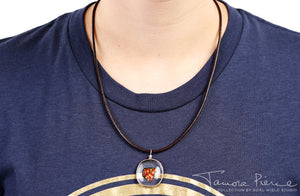 Ember glass necklace with brown cord on model.