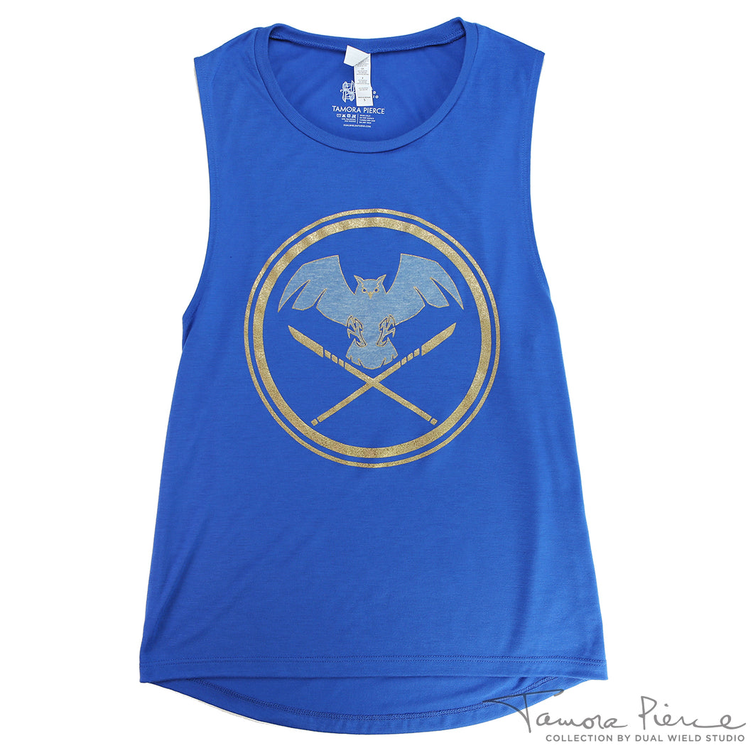 Blue tank with heather owl flying above crossed gold foil glaives, encircled in gold foil.
