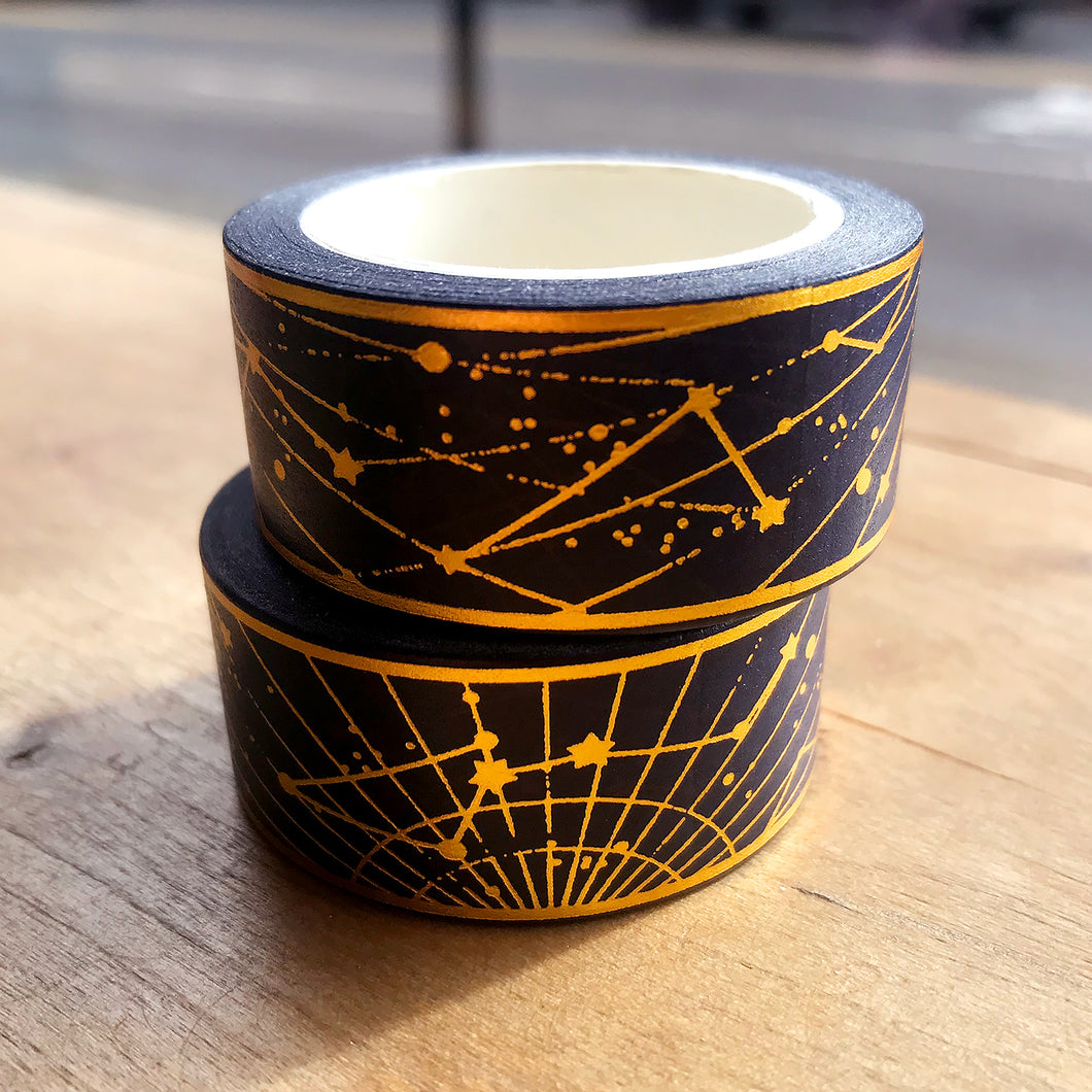 Gold foil constellation washi tape on wooden table.